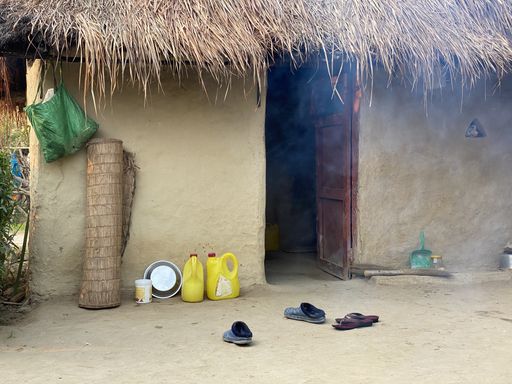 An old hut with household items outdoors