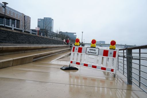 An "Achtung Hochwasser - attention high tidewater" sign near the River Rhine in Cologne, Germany