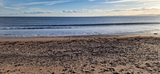 A stunning view of Exmouth Beach in England, showcasing its sandy shoreline and crystal blue waters
