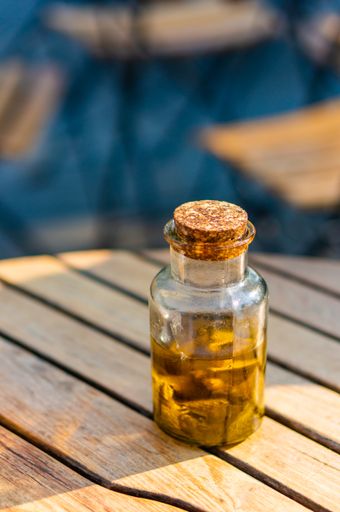 A vertical shot of a small glass jar on a wooden surface