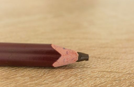 A closeup shot of a graphite pencil on a wooden surface