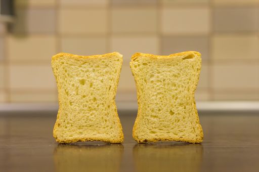 A selective focus shot of sliced toast bread on a wooden surface
