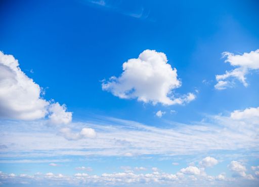 A beautiful sky featuring an array of white, fluffy clouds amidst a bright blue backdrop