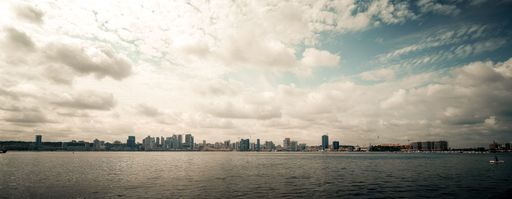 A stunning panoramic view of the bustling Luanda cityscape with a body of water in the foreground