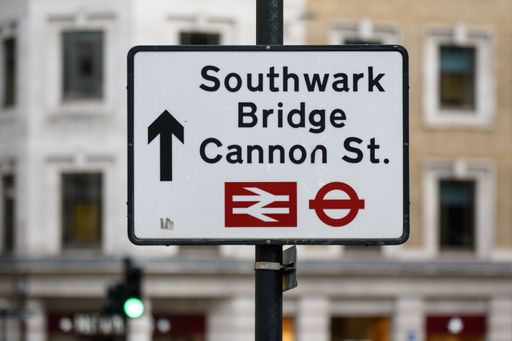 A road sign on a street in London directs traffic and people towards Southwark Bridge and Cannon Street stations in central London
