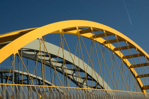 The fragments of a modern yellow and grey construction with a blue background