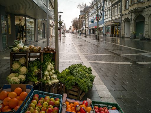 empty streets on a rainy day with vegetables of the only opened shop in the second lockdown based on the Corona pandemic
