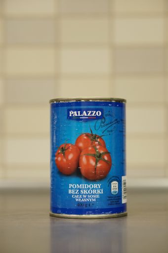 Palazzo tomatoes without skin in a can standing on a table