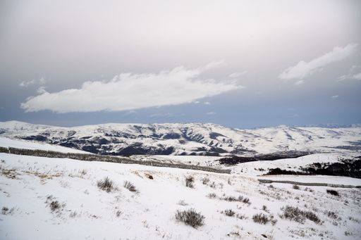 A beautiful landscape of a snowy field and rocky steep mountains of Arm