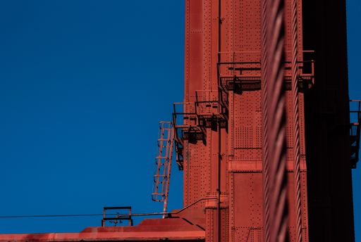 A low angle shot of metal construction with the clear blue sky in the background