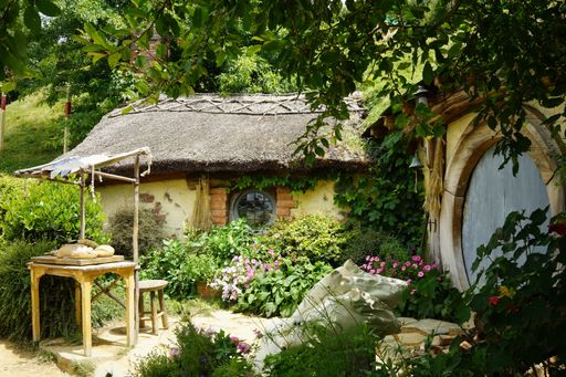 A beautiful building in the park with wooden doors and a roof surrounded by lush nature