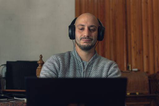 A closeup shot of a male working on his computer from home - new normal concept