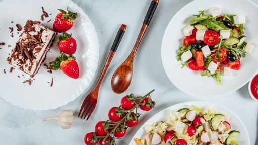 An overhead shot of a table of delicious dishes and dessert