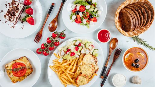 An overhead shot of a table of delicious dishes and dessert