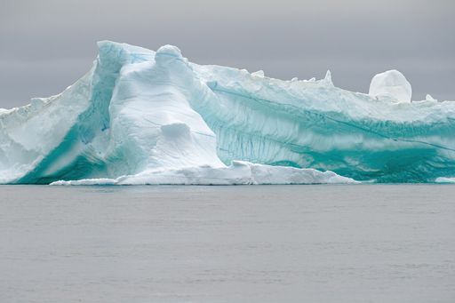 A wide-angle lens shot of a massive iceberg at Disko Bay, Greenland