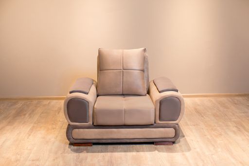 A closeup shot of a single brown sofa on a wooden floor