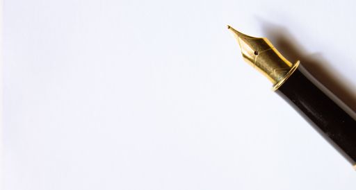 Close-up of a fountain pen on a notebook. Concept of writing poetry. International Poetry Day