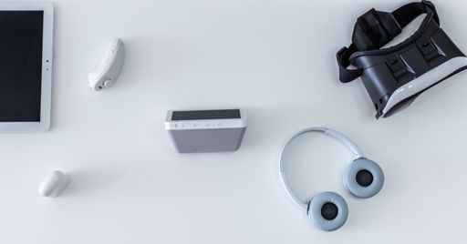 A high angle shot of home tech entertainment equipment: tablets, headphones, virtual reality glasses