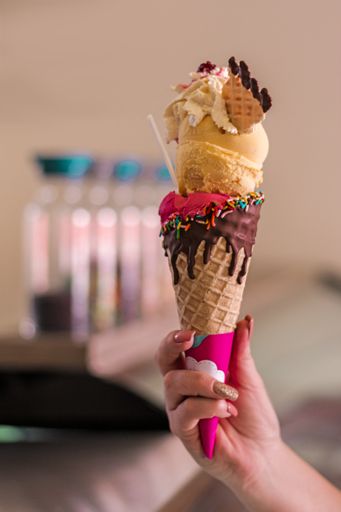 A selective focus shot of a female hand holding a tasty appetizing ice cream