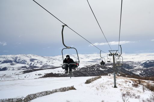 The skiers riding the lift chair during the skiing season in Armenia, Tsaghkadzor