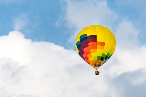 A low angle shot of a flying colorful air baloon in the air during a festival in Igualada, Barcelona, Catalonia