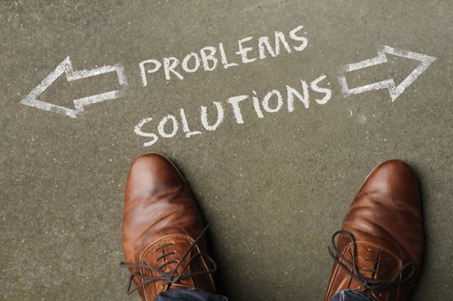 A high angle shot of problems and solutions marked with opposite directions on the ground