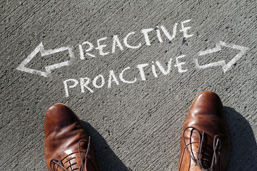 A high angle shot of reactive and proactive marked with opposite directions on the ground