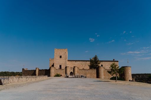 A beautiful exterior view of the Pedraza castle against a clear blue sky