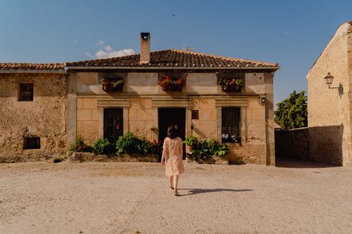 A female walking near the Iglesia de San Juan Bautista, Pedraza, Spain