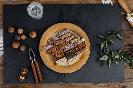 A top view of a plate of assorted homemade sweets with nuts and leaves