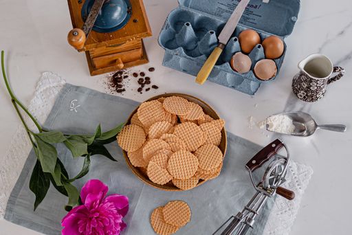 A top view of ready waffle cookies and their ingredients on the table