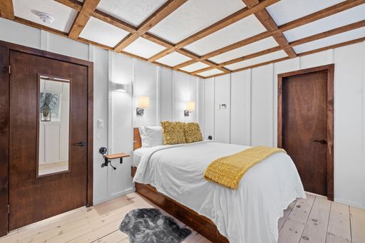 A stylish modern bedroom with a large bed and lamps
