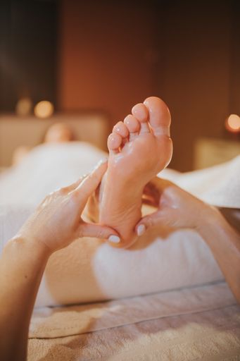 A female getting a professional foot massage in a beauty spa salon - beauty treatment concept