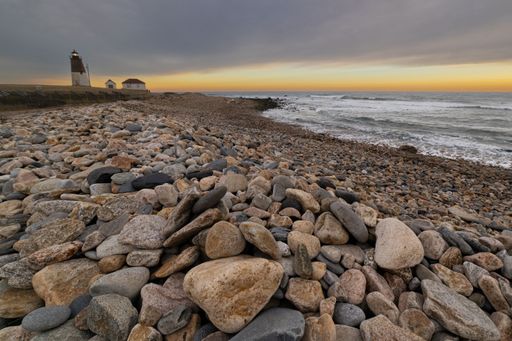The Point Judith Lighthouse Rhode Island at sunrise, illuminated by warm sunlight