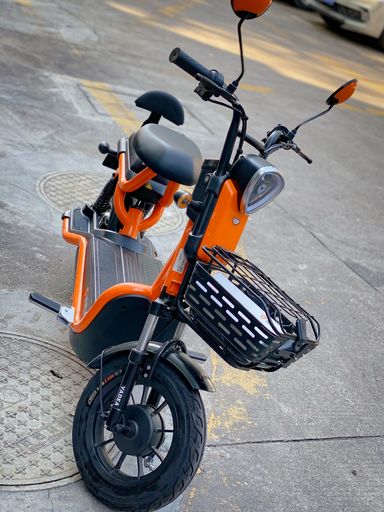 Pictures of my ebike in Shenzhen China, set against the backdrop of large commercial center in Nanshan