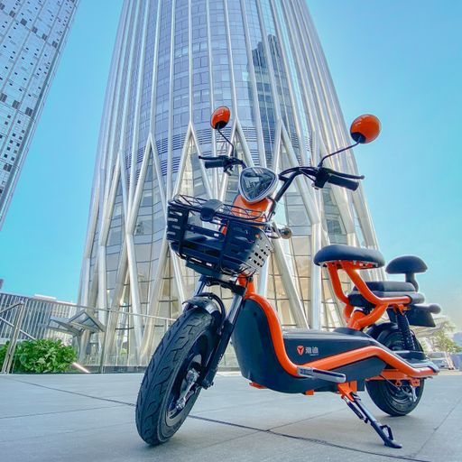 Pictures of my ebike in Shenzhen China, set against the backdrop of large commercial center in Nanshan