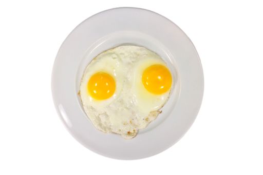 A high angle shot of sunny side up egg in a white plate with a white color in the background