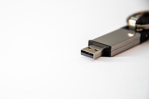 A closeup shot of a gray USB stick on a white surface