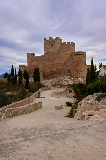 A vertical shot of the Atalaya Castle against the cloudy sky located in Villena, southern Spain