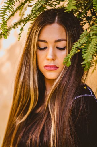 Picture of Gorgeous Model Girl Posing With Sensual Face Looking Down With Closed Eyes Plant Leaves On her Head