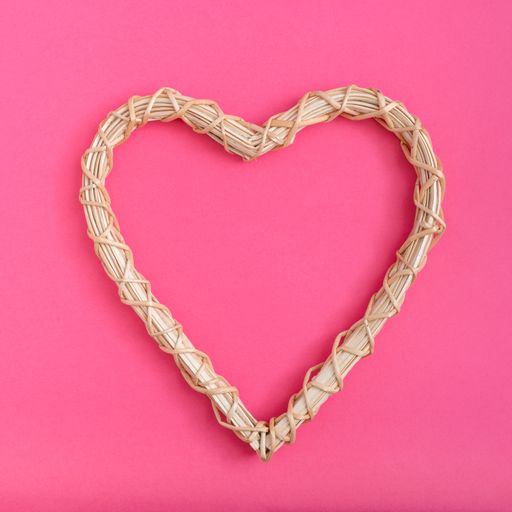 An overhead shot of a heart figure on a pink surface - Valentine's day concept