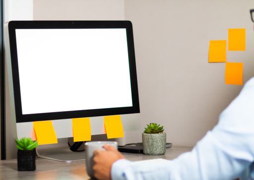 A closeup shot of a man in glasses working with a computer at home