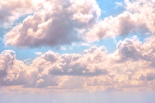 A beautiful shot of large breathtaking clouds in the blue sky - Perfect fantasy background or wallpaper