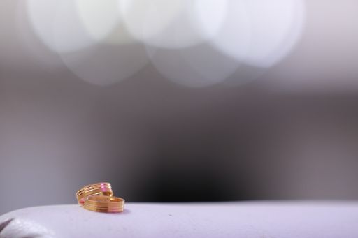A closeup shot of engagement rings with bokeh lights in the background