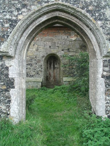 A vertical shot of an old monastery wall with an arch