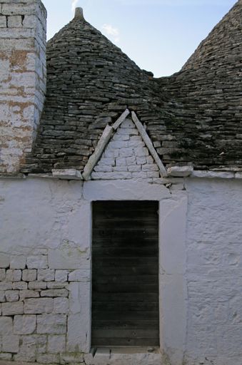 A vertical shot of white buildings in Alberobello Alberobello Italy
