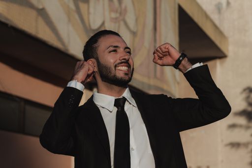 A closeup shot of a very happy successful gesturing businessman-business concept.
