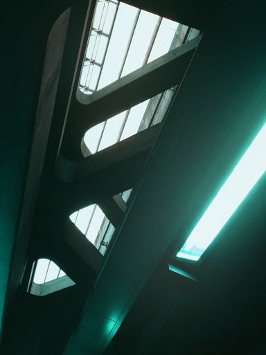 A vertical shot of a modern ceiling with neon light on the side - cool background or wallpaper