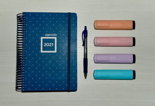 A closeup shot of notebook on a desk 2021 and pens