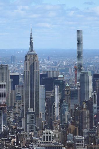 Aerial view of New York skyline, amazing view of New York city, Midtown Manhattan and an airplane flying on top of the buildings